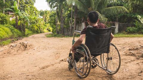 A paraplegic man on the side of a road