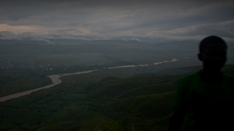 man viewing river from hill