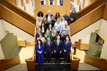 birds-eye shot of the HHI team posting on a staircase with the award recipient
