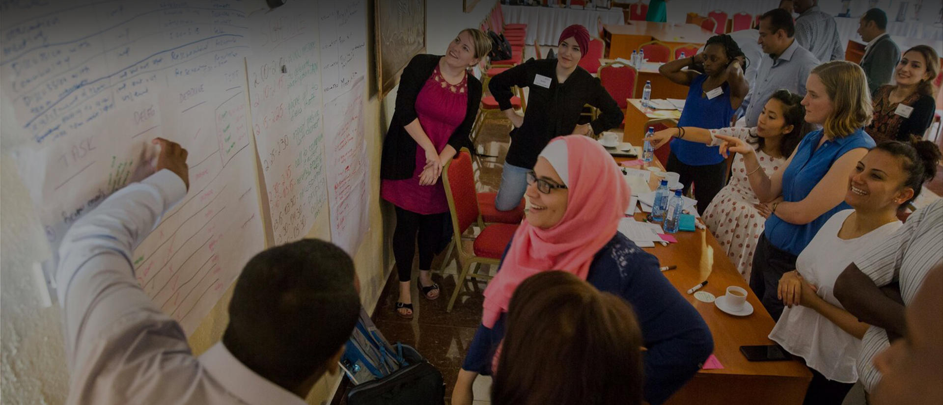 group of students standing in front of white board