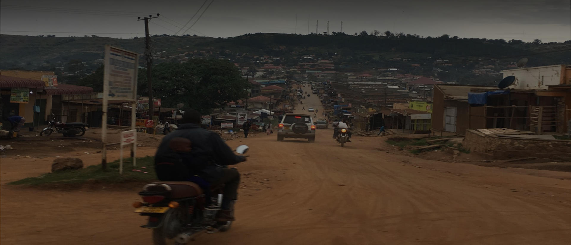 man riding motor bike on dirt road
