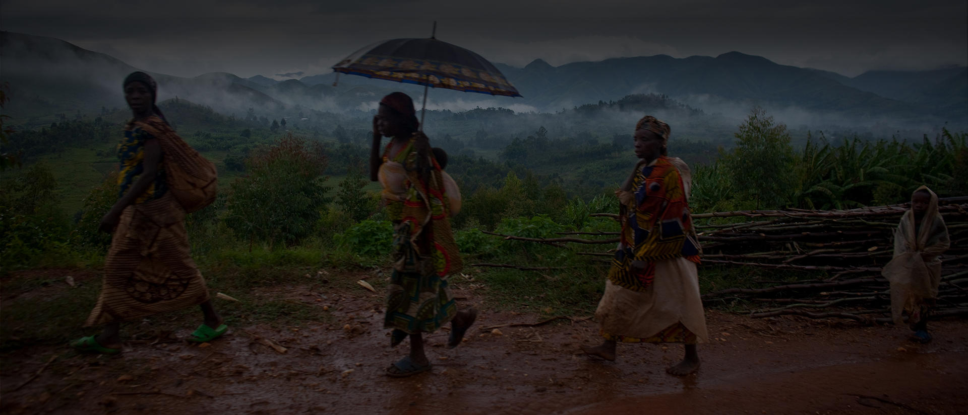 people walking on muddy road