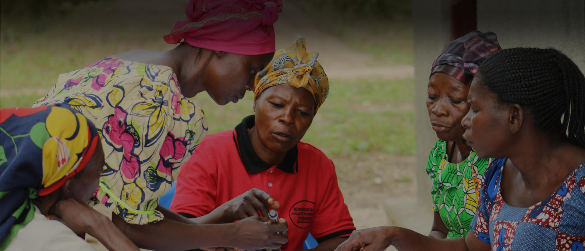african women talking around table