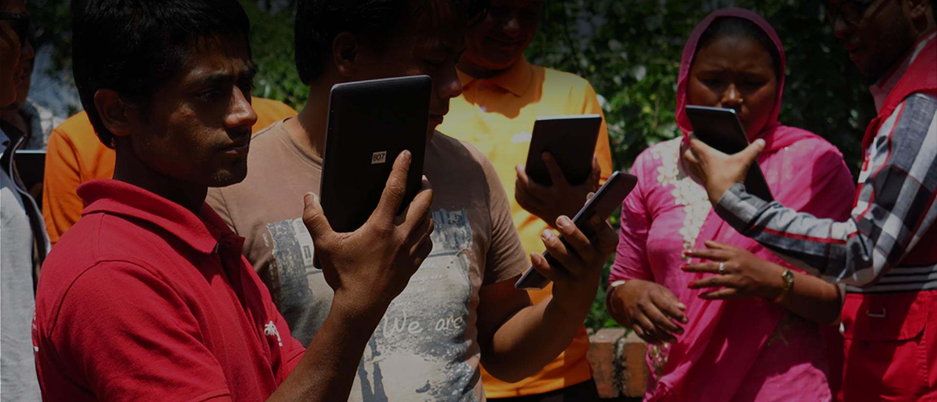 people staring at tablets