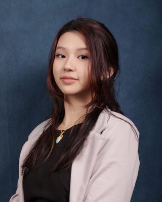 Michelle Wong against blue background